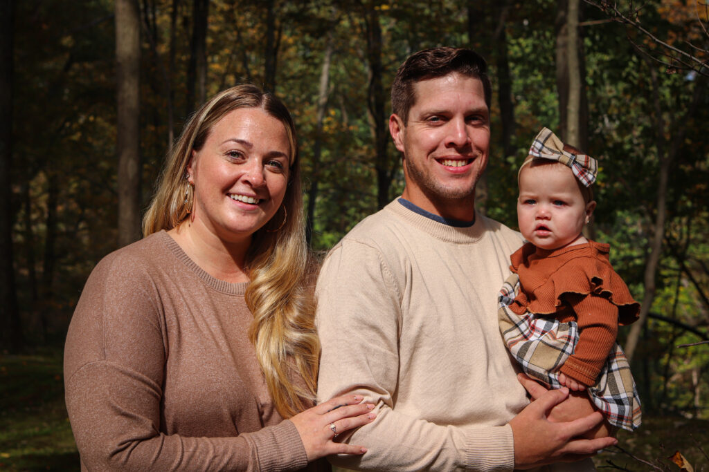 Mom and Dad hold little girl