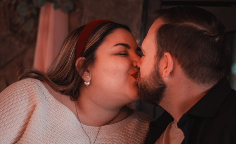 Man and woman kiss at Lawnhaven