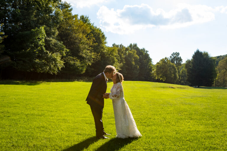 Bride and groom share a kiss under the sun