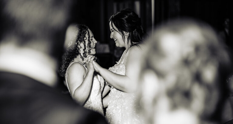 Two brides share a dance