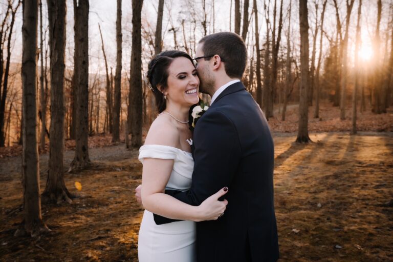 Bride smiles over groom's shoulder